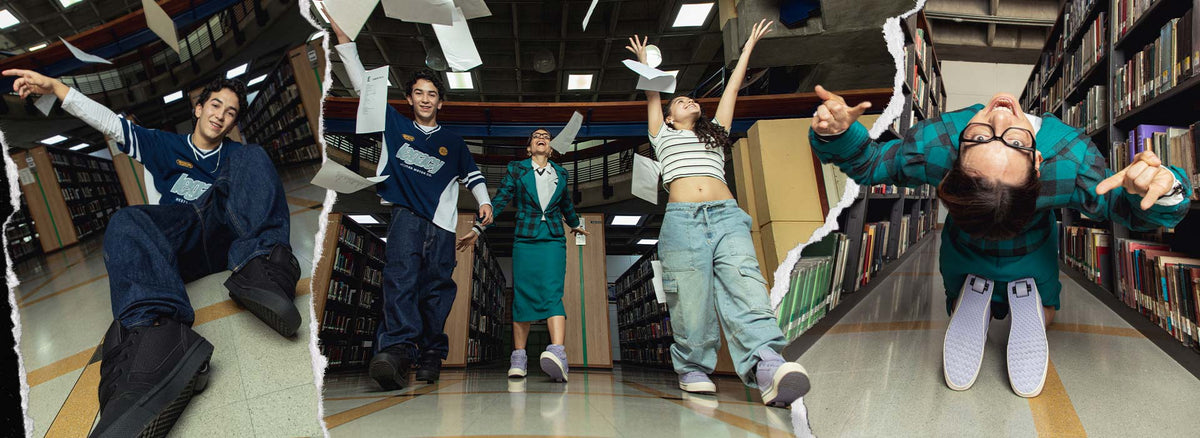 People pose dynamically in a library aisle wearing Heelys.